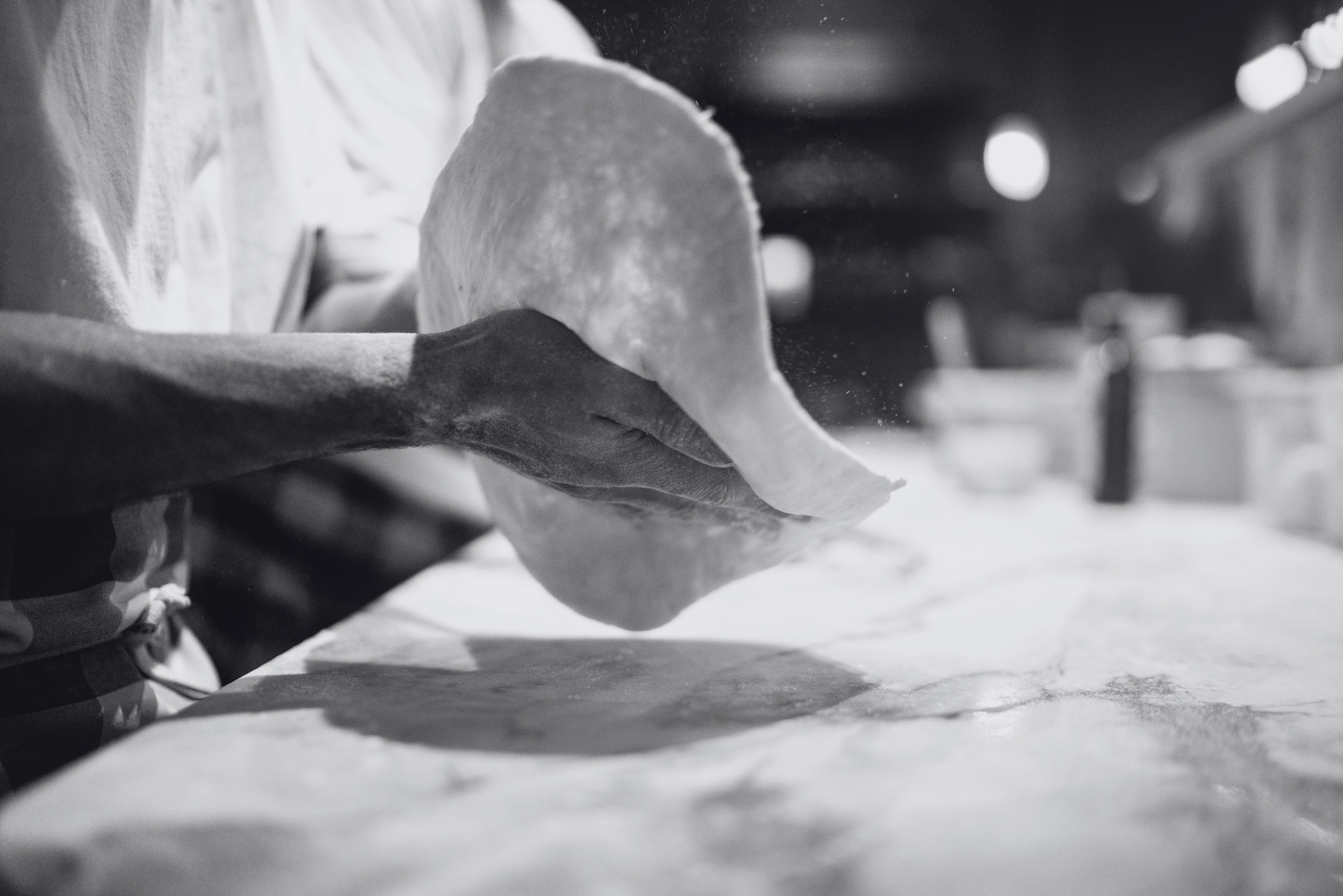 a photo of a person making a pizza